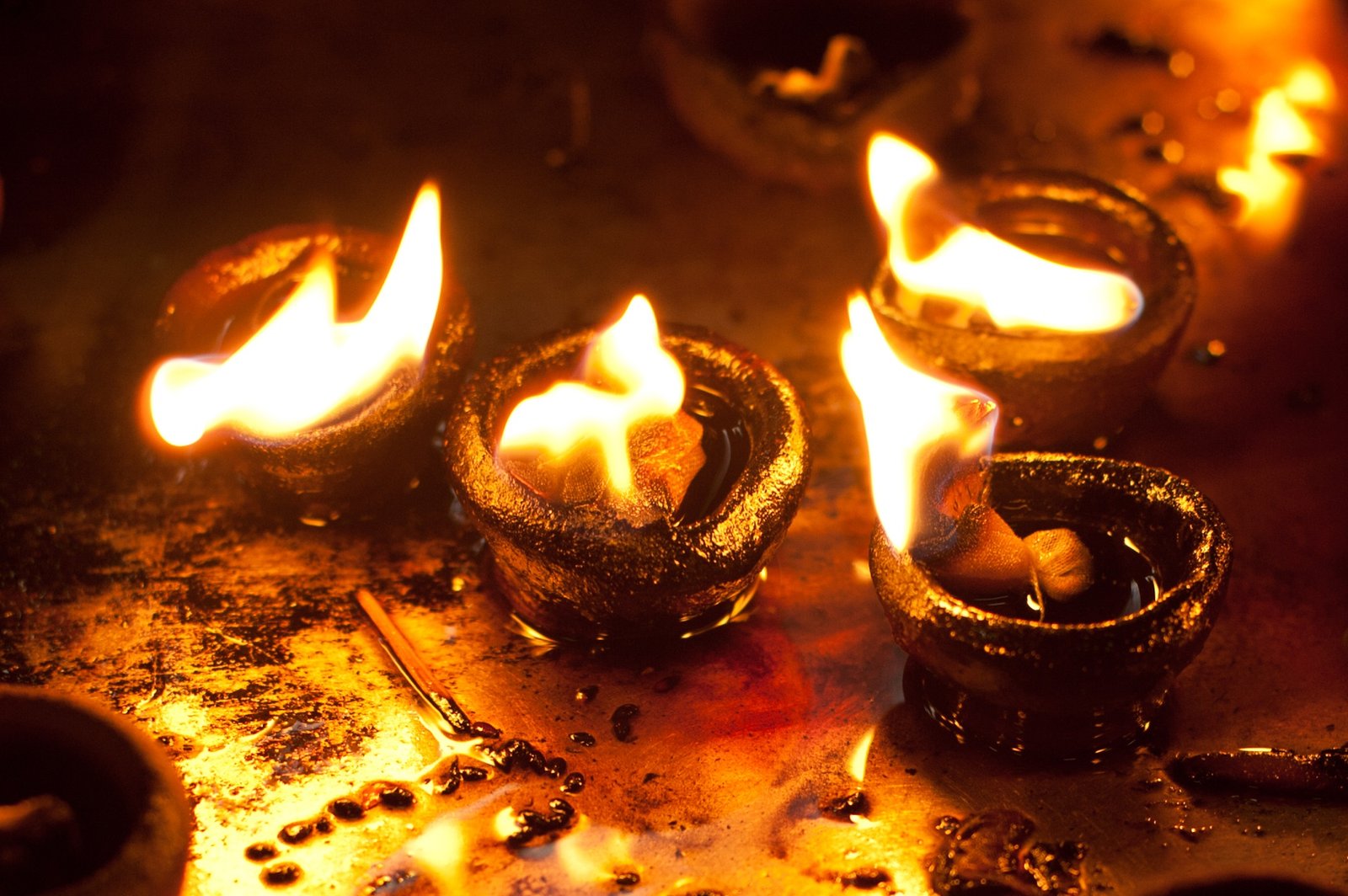 Burning oil lamps at Hindu temple. India